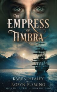 The-Empress-of-Timbra-Cover A three-masted sailing ship is nearing a mountainous bay. The sun is rising or setting over a mountain-top palace. Above the gold-lettered title "The Empress of Timbra"m we see a pale young face with blue eyes staring at the reader.